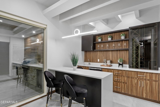 bar featuring sink, light tile flooring, dishwashing machine, and beamed ceiling