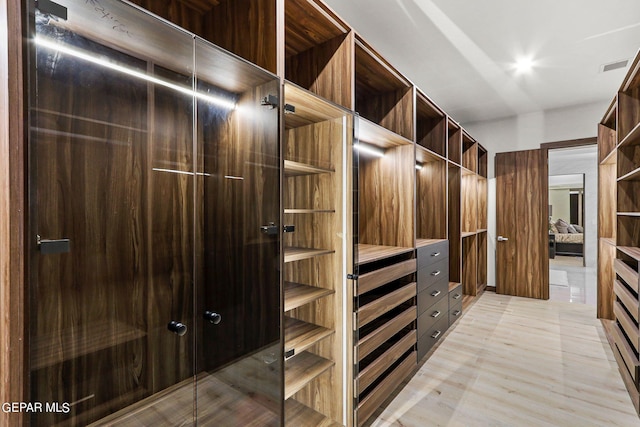 walk in closet featuring light hardwood / wood-style floors