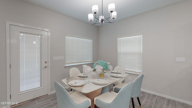 dining area with a chandelier and dark hardwood / wood-style flooring