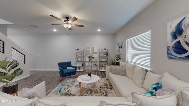 living room with dark hardwood / wood-style floors and ceiling fan