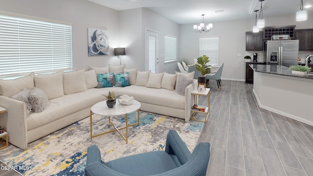 living room featuring light hardwood / wood-style floors and an inviting chandelier