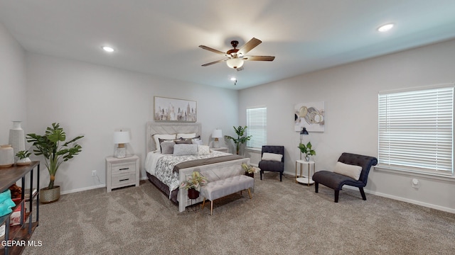bedroom with ceiling fan and light carpet