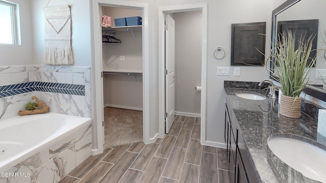 bathroom with tiled bath and dual vanity