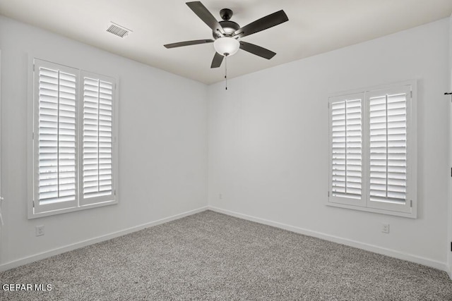 carpeted spare room featuring ceiling fan