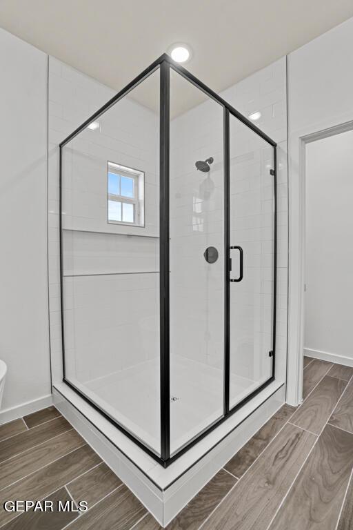 bathroom with a shower with shower door