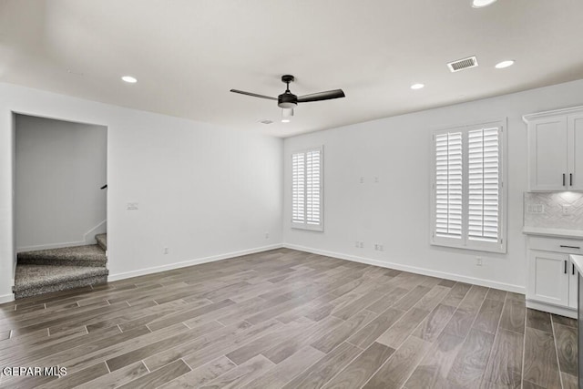 empty room featuring light wood-type flooring and ceiling fan