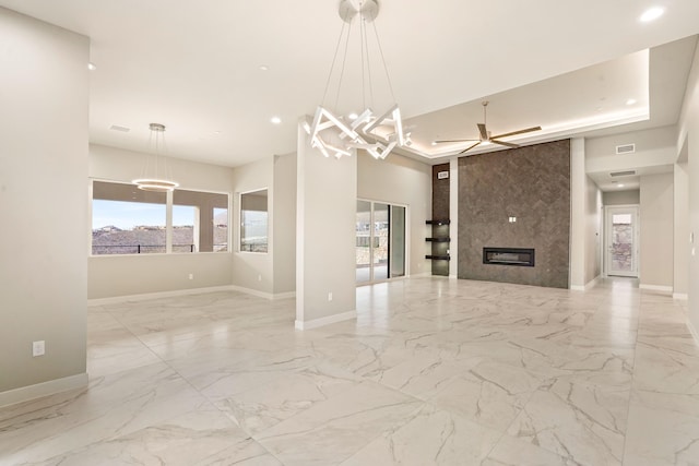 unfurnished living room with a fireplace and an inviting chandelier