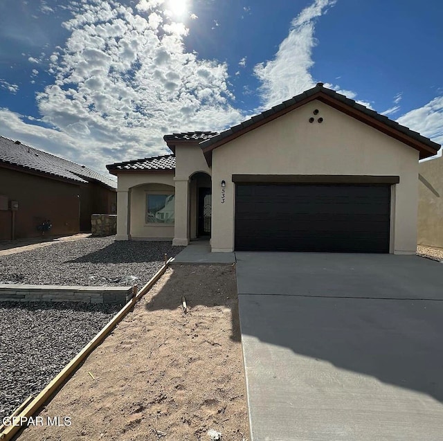 mediterranean / spanish-style house featuring a garage