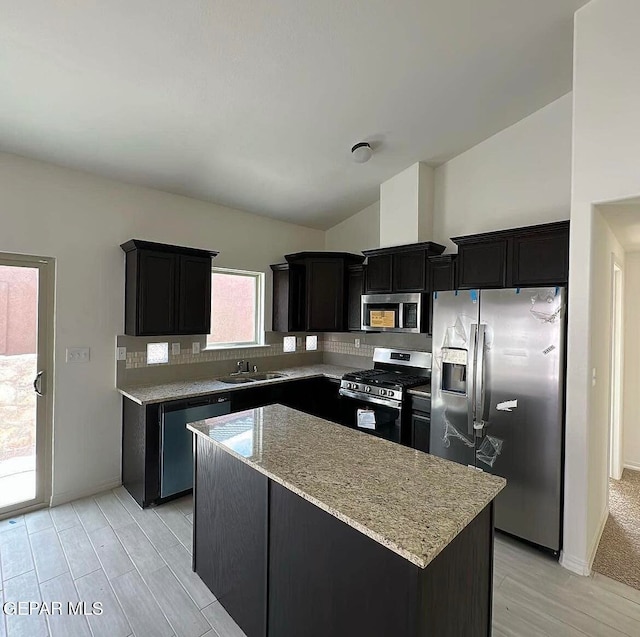 kitchen featuring a center island, tasteful backsplash, a wealth of natural light, and stainless steel appliances