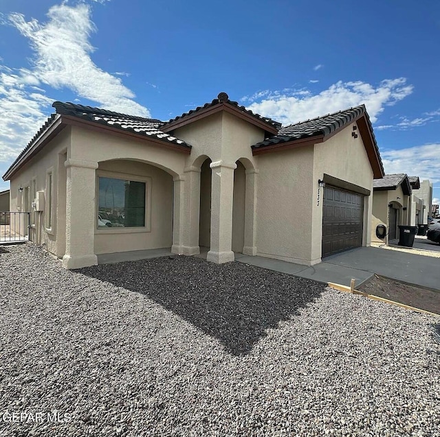 mediterranean / spanish-style home featuring a garage