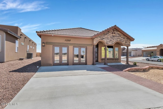 exterior space with french doors and central AC