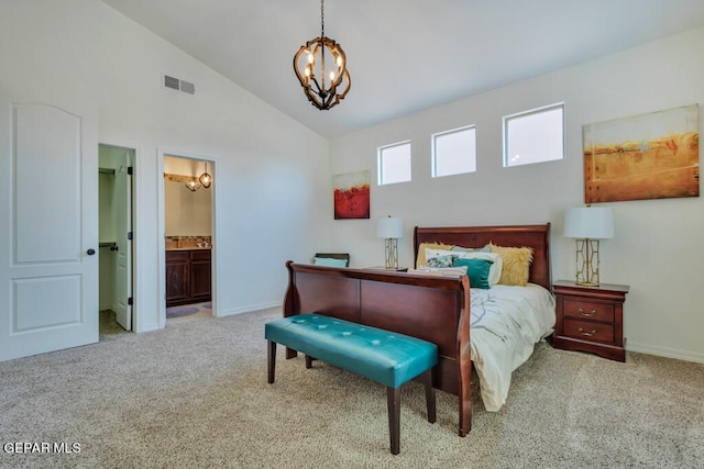 bedroom with light carpet, connected bathroom, a notable chandelier, and lofted ceiling