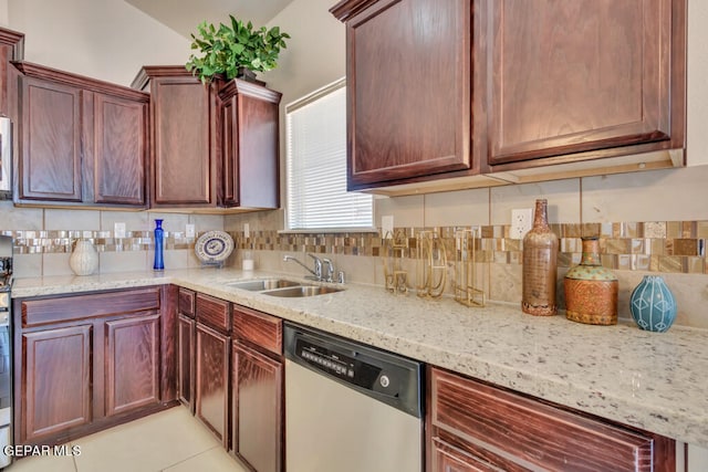 kitchen with light tile floors, backsplash, stainless steel dishwasher, and sink