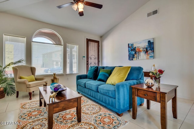 living room with ceiling fan, light tile floors, and lofted ceiling