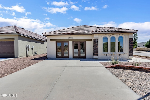 rear view of house featuring french doors and a garage