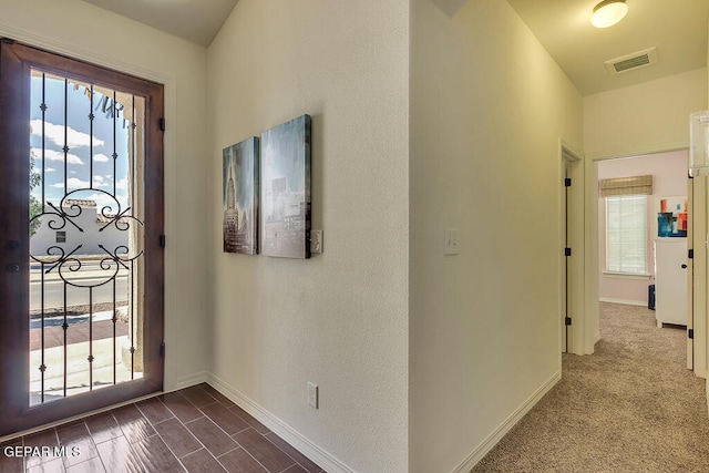 interior space featuring dark carpet