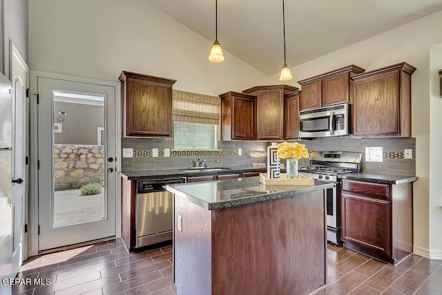 kitchen with plenty of natural light, a center island with sink, stainless steel appliances, and sink