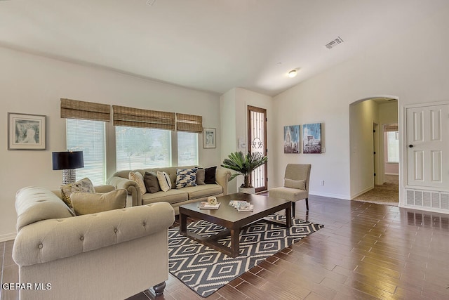 living room featuring dark hardwood / wood-style flooring and lofted ceiling