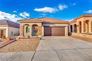 mediterranean / spanish-style house with a garage