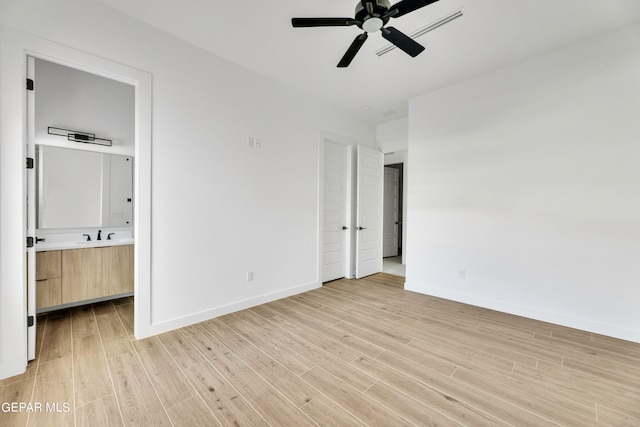 469 Country Oaks Dr, El Paso, TX 79932 - unfurnished bedroom with connected bathroom, light wood-type flooring, and ceiling fan