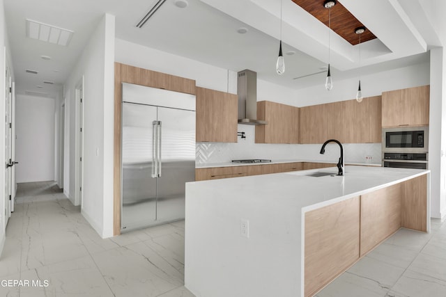 469 Country Oaks Dr, El Paso, TX 79932 - kitchen featuring wall chimney range hood, pendant lighting, sink, a large island, and built in appliances