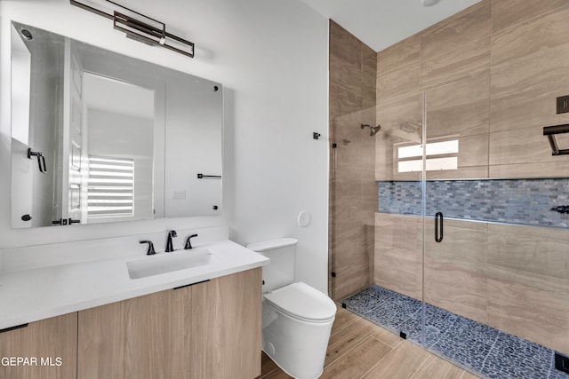 469 Country Oaks Dr, El Paso, TX 79932 - bathroom with hardwood / wood-style flooring, a healthy amount of sunlight, a shower with door, and toilet