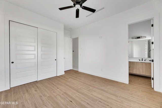 469 Country Oaks Dr, El Paso, TX 79932 - unfurnished bedroom featuring a closet, connected bathroom, light hardwood / wood-style flooring, and ceiling fan
