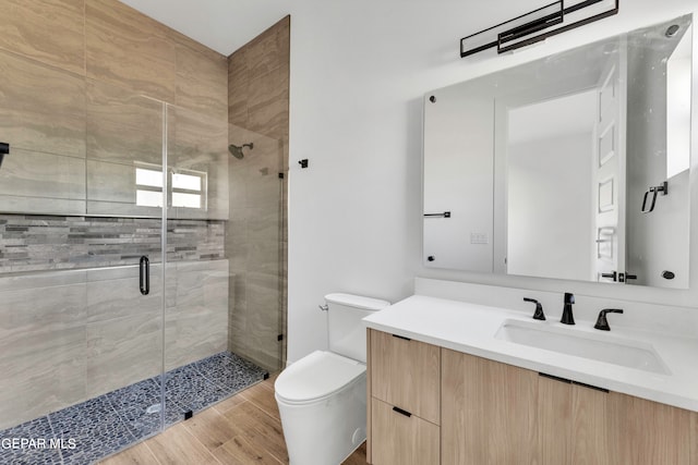 469 Country Oaks Dr, El Paso, TX 79932 - bathroom featuring hardwood / wood-style flooring, vanity, toilet, and a shower with shower door