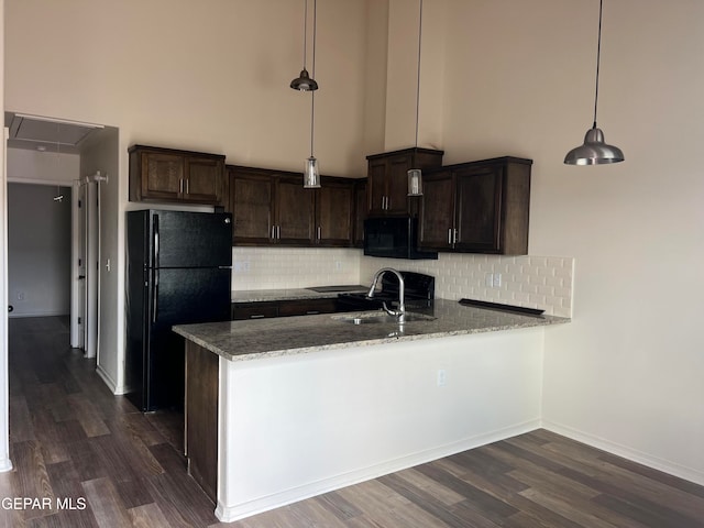 kitchen featuring tasteful backsplash, dark hardwood / wood-style flooring, sink, and black appliances