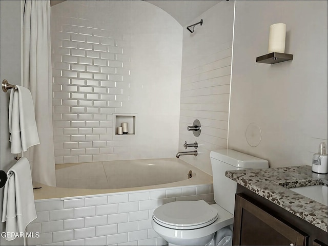 full bath featuring toilet, tiled shower / bath combo, and vanity