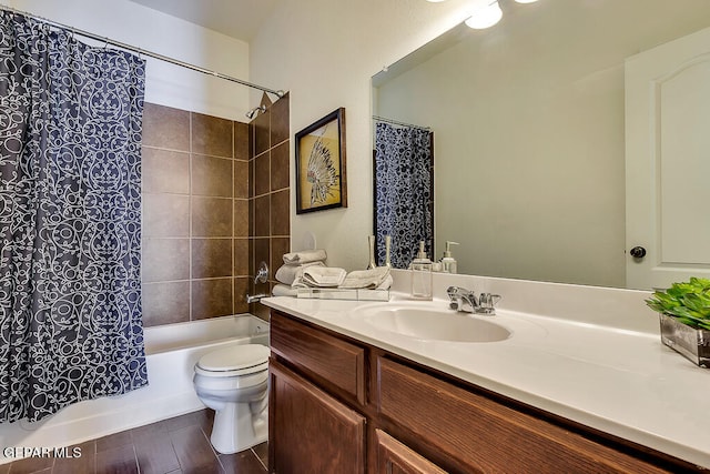 full bathroom featuring toilet, vanity with extensive cabinet space, and shower / bathtub combination with curtain