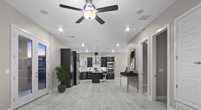 office featuring ceiling fan, light hardwood / wood-style floors, and french doors