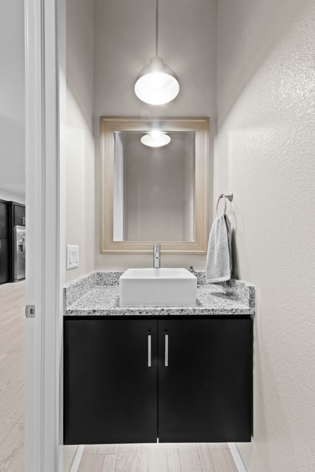 bathroom with vanity and wood-type flooring