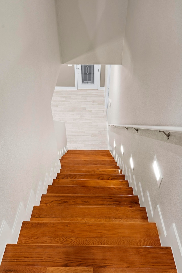 stairway with hardwood / wood-style floors