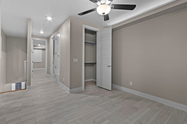 unfurnished bedroom with ceiling fan and light hardwood / wood-style floors