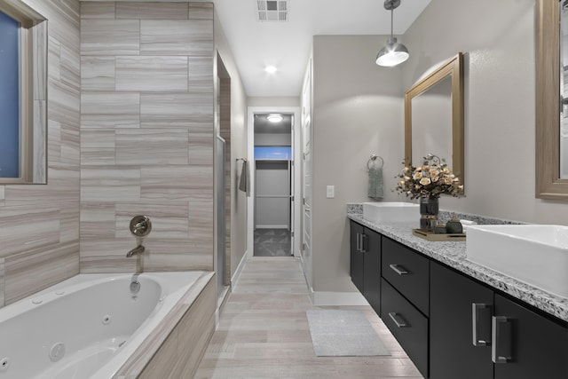 bathroom featuring vanity with extensive cabinet space, tile flooring, and double sink