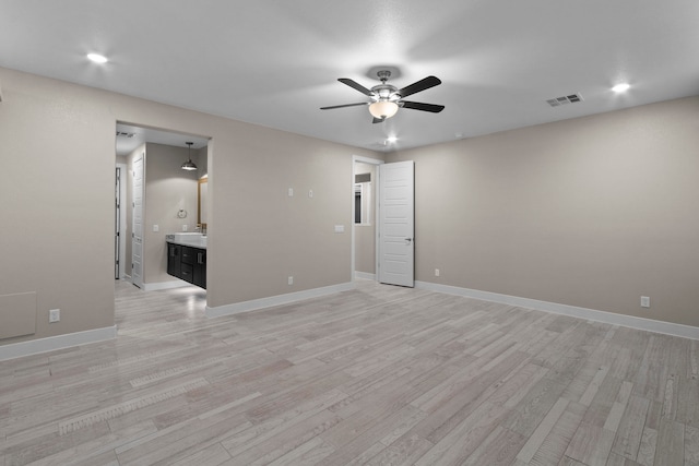 empty room featuring ceiling fan and light hardwood / wood-style flooring