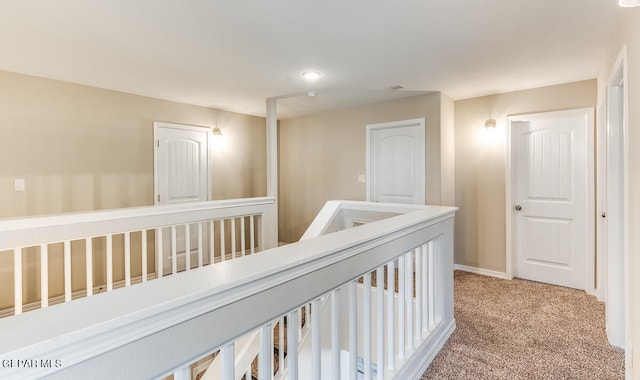 corridor featuring light colored carpet