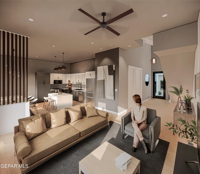 living room with sink, ceiling fan, and light hardwood / wood-style flooring