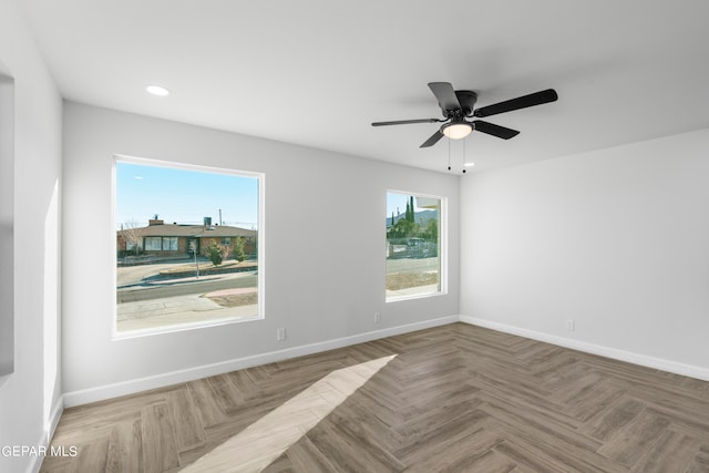 unfurnished room featuring light parquet flooring and ceiling fan