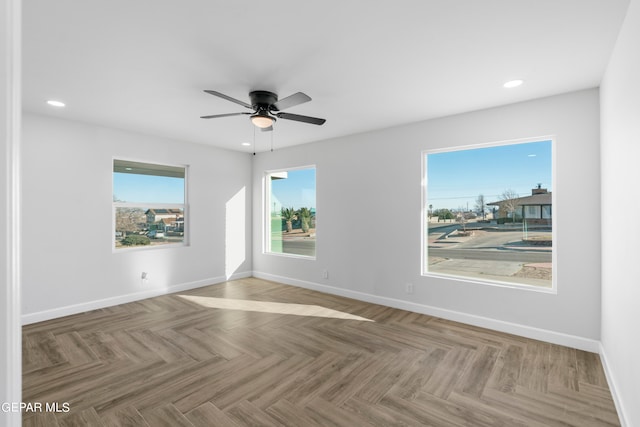 spare room featuring light parquet flooring and ceiling fan