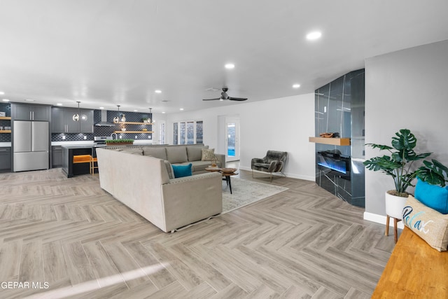 living room featuring light parquet floors and ceiling fan