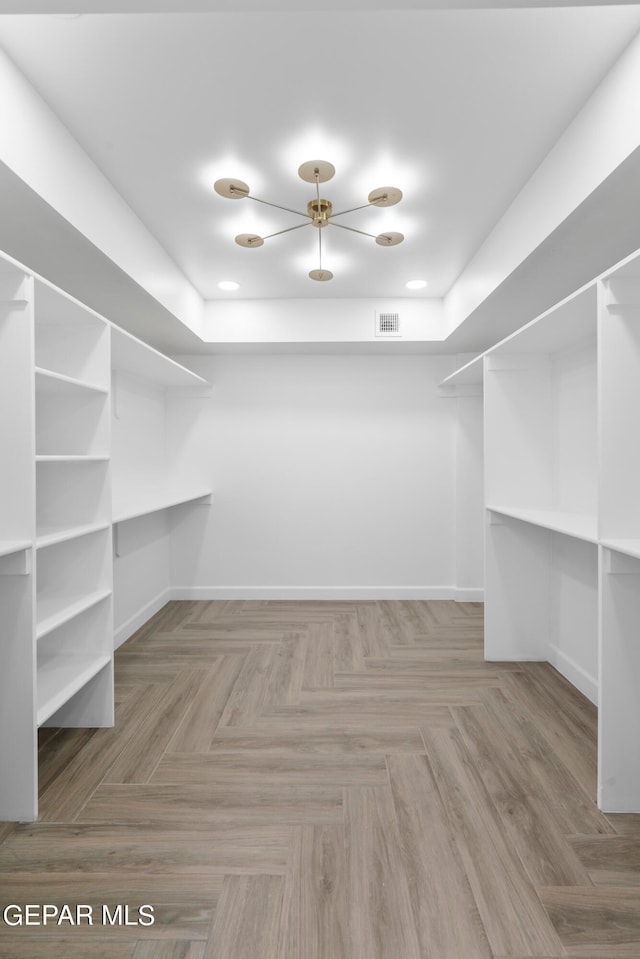 walk in closet featuring light parquet floors