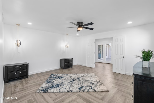 sitting room featuring ceiling fan and light parquet flooring