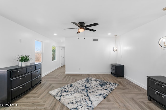 sitting room with ceiling fan and light parquet flooring