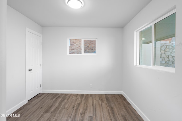 empty room with dark wood-type flooring