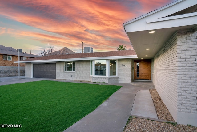 view of front facade featuring a lawn and a garage