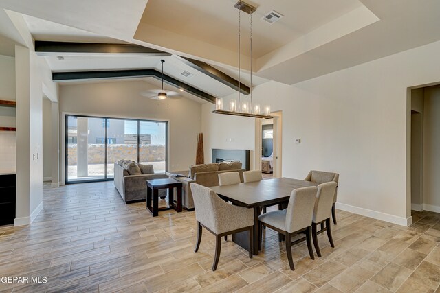 dining space featuring wood finish floors, visible vents, baseboards, and ceiling fan with notable chandelier