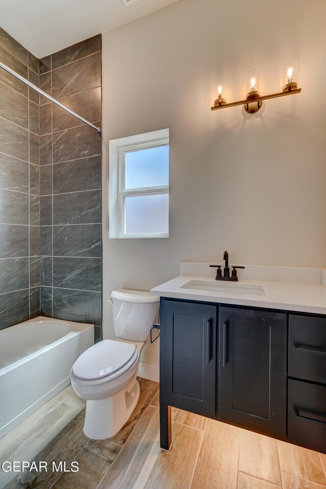 bathroom with toilet, vanity, and shower / bathing tub combination