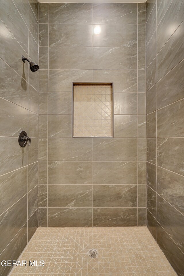 bathroom with tiled shower